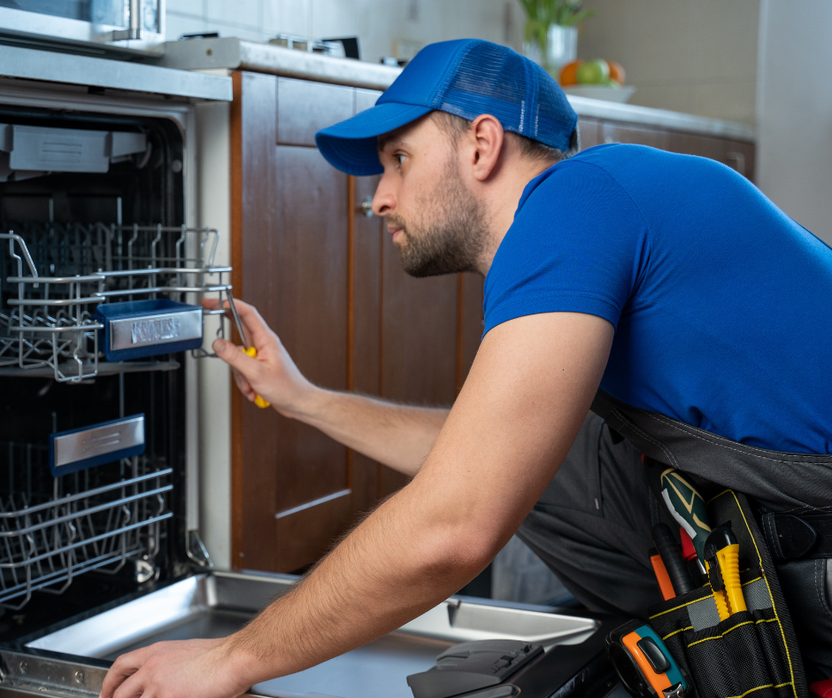 A man installs a new dishwasher 